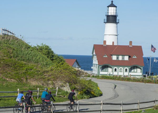 Group of cyclists approaching the Portland Head Light