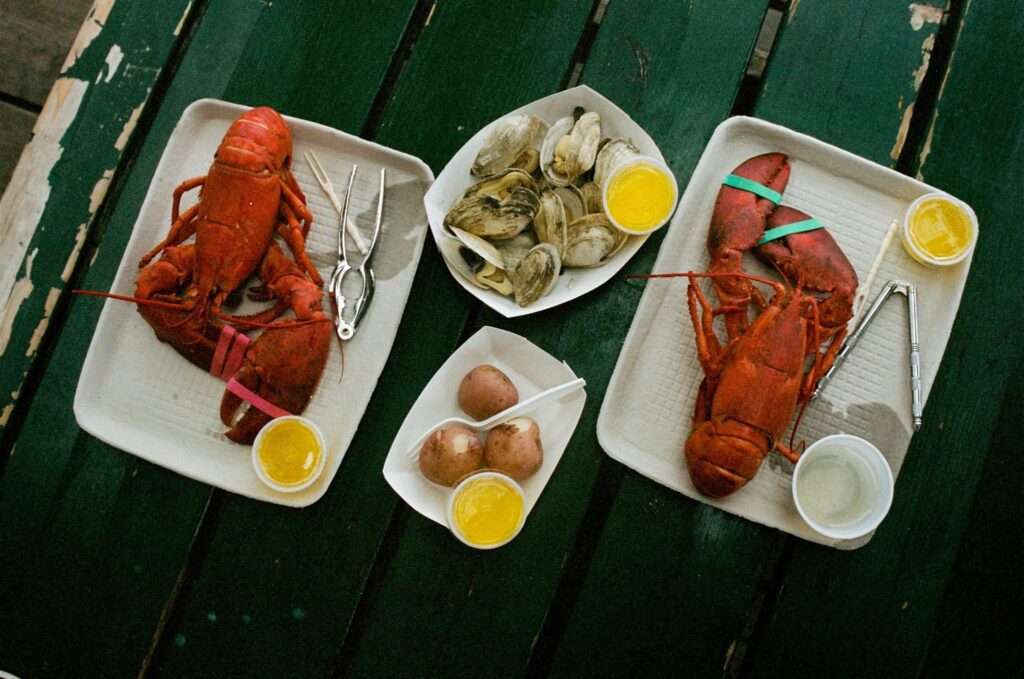Picture of lobsters and shellfish on a wooden table
